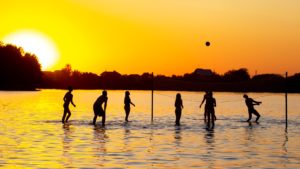 people play water volleyball. summer sports leisure